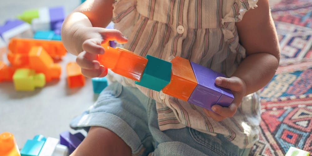 Closeup of toddler playing with blocks Closeup of toddler playing with blocks