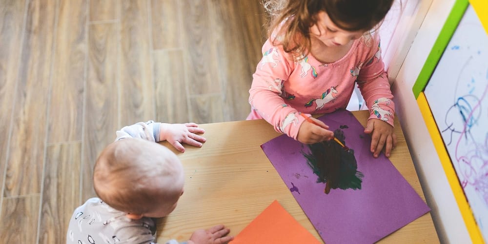 Young girl and baby drawing Young girl and baby drawing